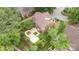 An aerial view of a brick home showcasing a landscaped backyard with a unique brick patio at 7031 Walton Heath Ln, Charlotte, NC 28277