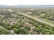 Aerial view of a beautiful community surrounded by lush green trees and a nearby highway at 7031 Walton Heath Ln, Charlotte, NC 28277