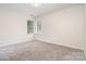 Serene bedroom featuring neutral walls, plush carpeting, and natural light streaming through the windows, creating a cozy space at 7031 Walton Heath Ln, Charlotte, NC 28277