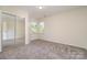 Bright bedroom featuring mirrored closet doors and natural light streaming through the windows, creating a cozy space at 7031 Walton Heath Ln, Charlotte, NC 28277