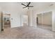 Expansive bedroom boasting a ceiling fan and mirrored closet, offering a bright and spacious retreat at 7031 Walton Heath Ln, Charlotte, NC 28277