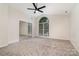 Bedroom with a mirrored closet and large arched window at 7031 Walton Heath Ln, Charlotte, NC 28277