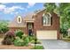 Charming brick home featuring a manicured lawn, two-car garage, and inviting front entrance at 7031 Walton Heath Ln, Charlotte, NC 28277