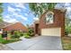 Charming brick home featuring a manicured lawn, two-car garage, and inviting front entrance at 7031 Walton Heath Ln, Charlotte, NC 28277