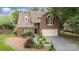 Charming brick home with a well-manicured front yard and a two-car garage at 7031 Walton Heath Ln, Charlotte, NC 28277