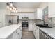 Bright eat-in kitchen with white cabinets, stainless appliances, and modern lighting at 7031 Walton Heath Ln, Charlotte, NC 28277