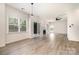 Bright living room with fireplace, sliding doors to outside, and light hardwood floors at 7031 Walton Heath Ln, Charlotte, NC 28277