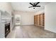 Bright living room featuring a fireplace, built-in shelving and light hardwood floors at 7031 Walton Heath Ln, Charlotte, NC 28277