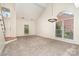 Spacious living room with vaulted ceilings and large windows at 7031 Walton Heath Ln, Charlotte, NC 28277