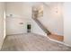 Open living room with stairs, high ceilings, and neutral carpet at 7031 Walton Heath Ln, Charlotte, NC 28277