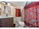 Well-lit bathroom with a wood vanity, mirror, and colorful shower curtain at 867 Bellegray Rd, Clover, SC 29710