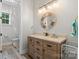 Well-lit bathroom with a stylish vanity, decorative mirror, and modern fixtures at 867 Bellegray Rd, Clover, SC 29710