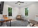 Relaxing bedroom featuring dual windows for natural light, a cozy chair, and workspace at 867 Bellegray Rd, Clover, SC 29710