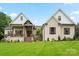 Charming brick home with a covered porch, manicured lawn, and professionally landscaped flowerbeds at 867 Bellegray Rd, Clover, SC 29710