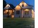 Beautifully lit home at night with professionally landscaped front yard at 867 Bellegray Rd, Clover, SC 29710