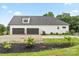 Exterior shot of a detached two-car garage with modern doors, white siding, and a well-kept lawn at 867 Bellegray Rd, Clover, SC 29710