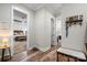 Hallway view showcasing wood floors and connecting to a bedroom and laundry room at 867 Bellegray Rd, Clover, SC 29710