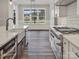 Chef's kitchen with high-end appliances, white subway tile backsplash, and hardwood flooring at 867 Bellegray Rd, Clover, SC 29710