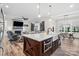 Open concept kitchen with large island, farmhouse sink, and view to living area at 867 Bellegray Rd, Clover, SC 29710