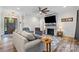 Cozy living room with stone fireplace, ceiling fan, and wood look flooring at 867 Bellegray Rd, Clover, SC 29710