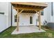 New construction patio with a wooden ceiling cover, concrete base, and sliding glass doors at 9214 Delancey Ln # 62, Concord, NC 28027