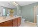 Bathroom with a double vanity, a wall mirror, and stylish decor at 10027 Juniper Trace Dr, Charlotte, NC 28277