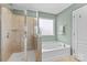 Bathroom featuring a glass shower, a soaking tub, and contemporary finishes at 10027 Juniper Trace Dr, Charlotte, NC 28277