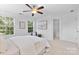 Cozy bedroom featuring a ceiling fan, neutral decor, and natural light at 10027 Juniper Trace Dr, Charlotte, NC 28277