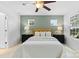 Comfortable bedroom featuring a ceiling fan, large windows, and a serene color palette at 10027 Juniper Trace Dr, Charlotte, NC 28277