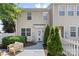 Back exterior of home with lush green landscaping and a cozy outdoor area at 10027 Juniper Trace Dr, Charlotte, NC 28277