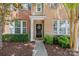Charming brick home with a welcoming black front door and manicured landscaping at 10027 Juniper Trace Dr, Charlotte, NC 28277