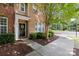 Inviting home entrance with a black door, manicured shrubs, and a sidewalk at 10027 Juniper Trace Dr, Charlotte, NC 28277