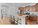 Modern kitchen features wood cabinets, granite counters, stainless steel appliances, and island seating at 10027 Juniper Trace Dr, Charlotte, NC 28277