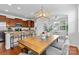 Open layout kitchen features granite counters and seating that connects to a bright dining area at 10027 Juniper Trace Dr, Charlotte, NC 28277