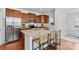 Bright kitchen boasts granite counters, stainless appliances, and island with seating for three at 10027 Juniper Trace Dr, Charlotte, NC 28277
