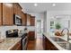 Well-equipped kitchen features stainless appliances, granite counters and adjacent dining space at 10027 Juniper Trace Dr, Charlotte, NC 28277
