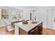 Open kitchen features a double sink on the island with dining area near large windows at 10027 Juniper Trace Dr, Charlotte, NC 28277