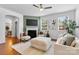 Bright living room with fireplace, ceiling fan, and stylish neutral furniture at 10027 Juniper Trace Dr, Charlotte, NC 28277