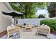 Cozy outdoor seating with a white fence and landscaped surroundings at 10027 Juniper Trace Dr, Charlotte, NC 28277