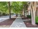 Peaceful street view of a residential neighborhood lined with trees and sidewalks at 10027 Juniper Trace Dr, Charlotte, NC 28277