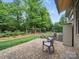 Back patio area offers an inviting space for outdoor gatherings with serene views of the private, wooded yard at 1004 Fairbanks Ct, Indian Trail, NC 28079