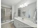 Well-lit bathroom featuring a glass-enclosed shower, white cabinets, and elegant countertops at 1004 Fairbanks Ct, Indian Trail, NC 28079