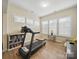 Bonus room featuring a treadmill and natural light; perfect for exercise and relaxation with hardwood floors at 1004 Fairbanks Ct, Indian Trail, NC 28079