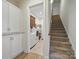 Hallway view to laundry room with washer and dryer, stairs, and abundant storage at 1004 Fairbanks Ct, Indian Trail, NC 28079