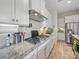 Well-equipped kitchen features stainless steel appliances, granite countertops, a gas range, and white cabinets at 1004 Fairbanks Ct, Indian Trail, NC 28079