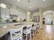 Gourmet kitchen with granite countertops, stainless steel appliances, and breakfast bar seating at 1004 Fairbanks Ct, Indian Trail, NC 28079