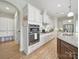 Bright kitchen features white cabinetry, stainless steel appliances, granite countertops, and hardwood flooring at 1004 Fairbanks Ct, Indian Trail, NC 28079