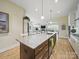 Kitchen features granite countertops, wooden floors, stainless steel appliances, and an eat-in dining area at 1004 Fairbanks Ct, Indian Trail, NC 28079