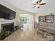 Cozy living room featuring fireplace, television, hardwood floors, and comfortable seating at 1004 Fairbanks Ct, Indian Trail, NC 28079