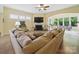 Spacious living room features a large sectional sofa, hardwood floors, a fireplace, and plenty of natural light at 1004 Fairbanks Ct, Indian Trail, NC 28079
